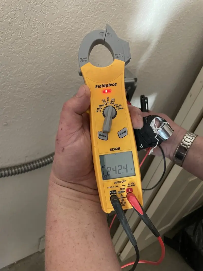 Voltage testing with clamp meter during Recessed Lighting Installation in Calumet
